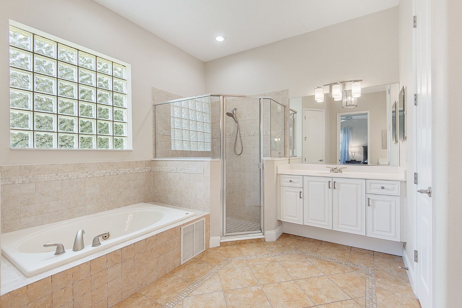 Primary bathroom with jetted tub and glass shower